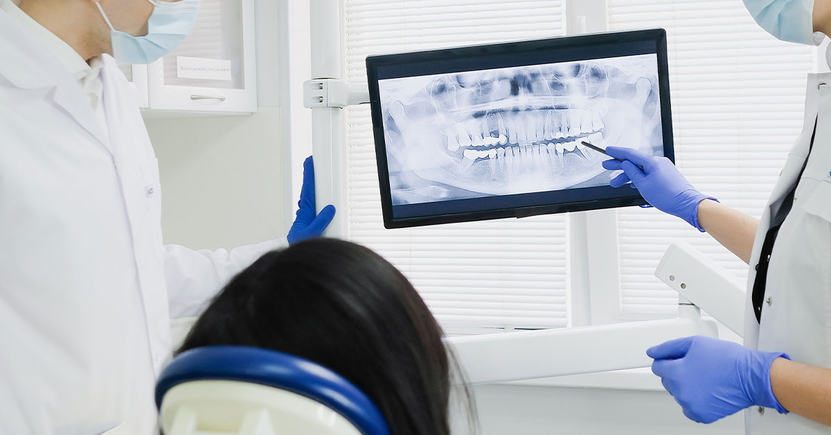 Dental xrya being examined by the dentists and patient on a screen