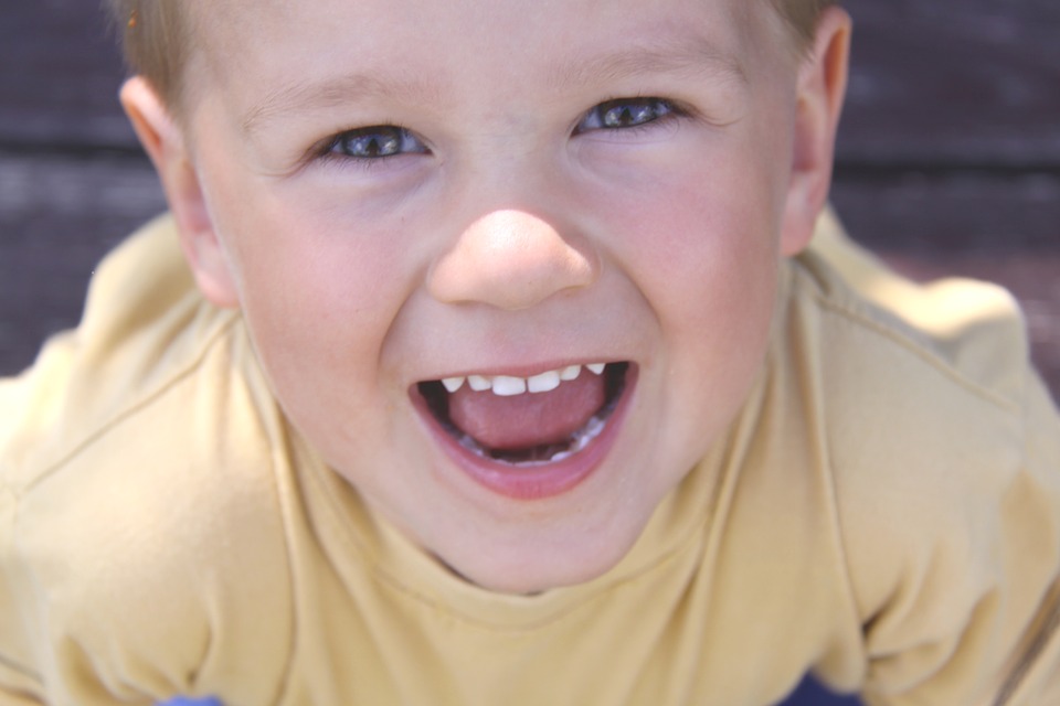 Boy smiling with healthy, white teeth- dental health tips